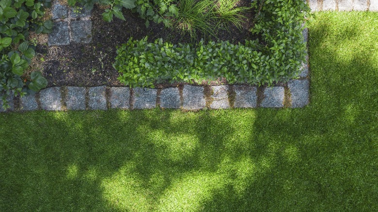 Rows of rough-cut natural stone used as paver edging