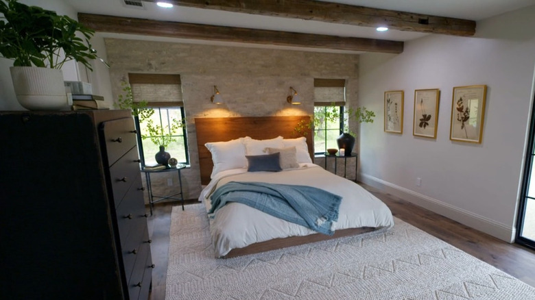 Stone accent wall behind bed