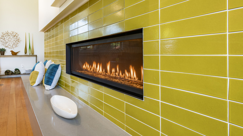 Electric fireplace with yellow tile around it