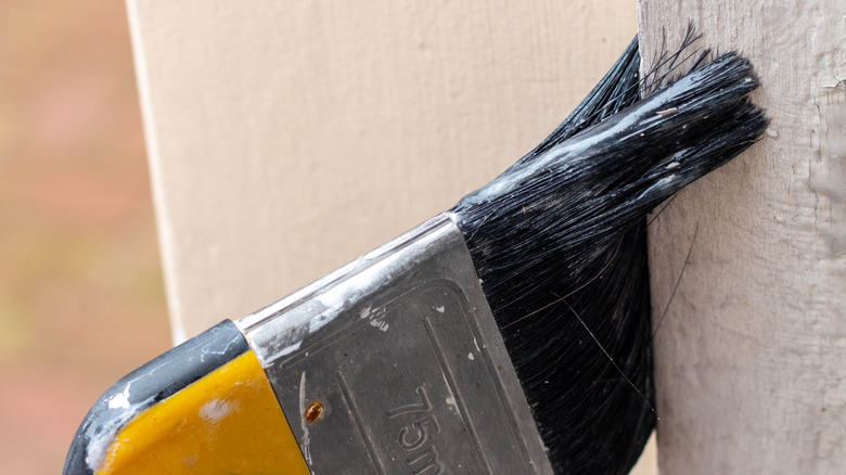 Applying paint stripper on a door frame