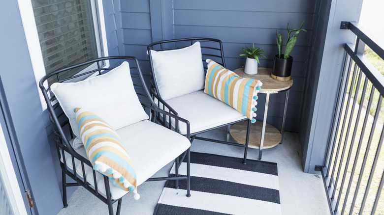 two patio chairs with cushions