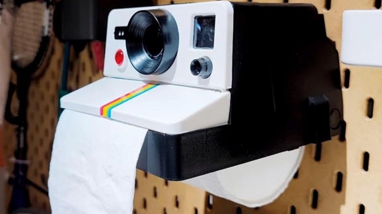 A retro-style instant Polaroid camera toilet paper holder