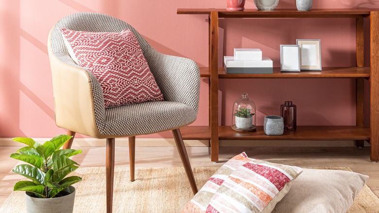 Linen sofa-style chair in living room with pink walls