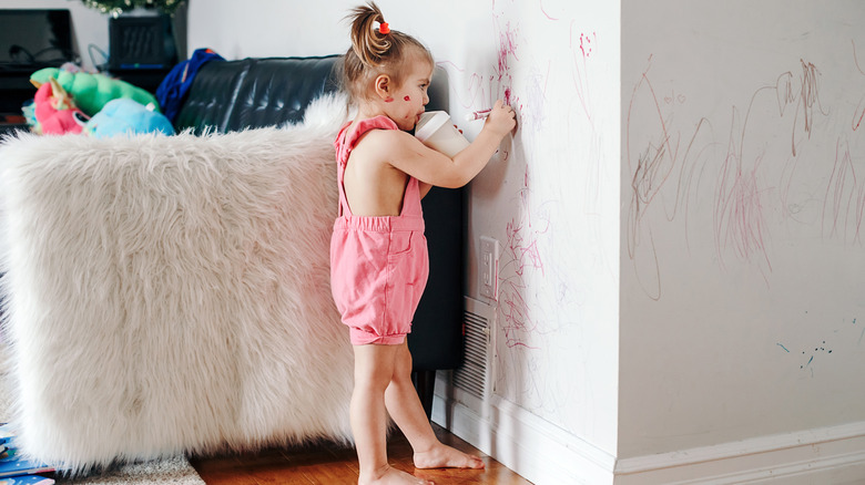 Child drawing on walls