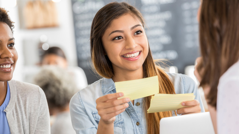 Student holding index cards