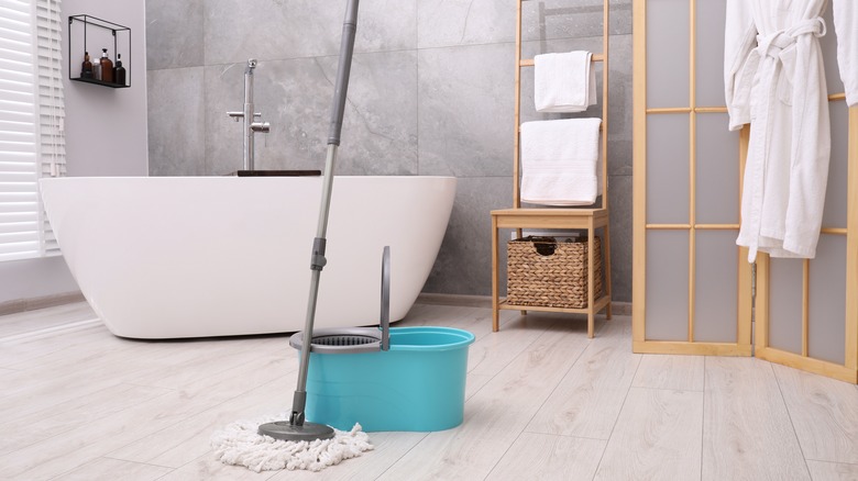 Mop and bucket in bathroom