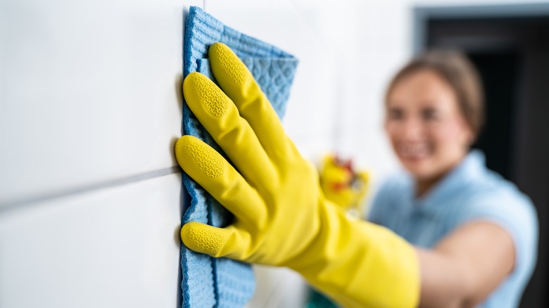 Woman cleaning shower tile