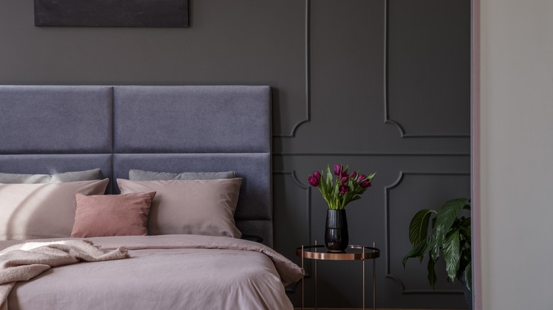 Double bed against a slate gray wall