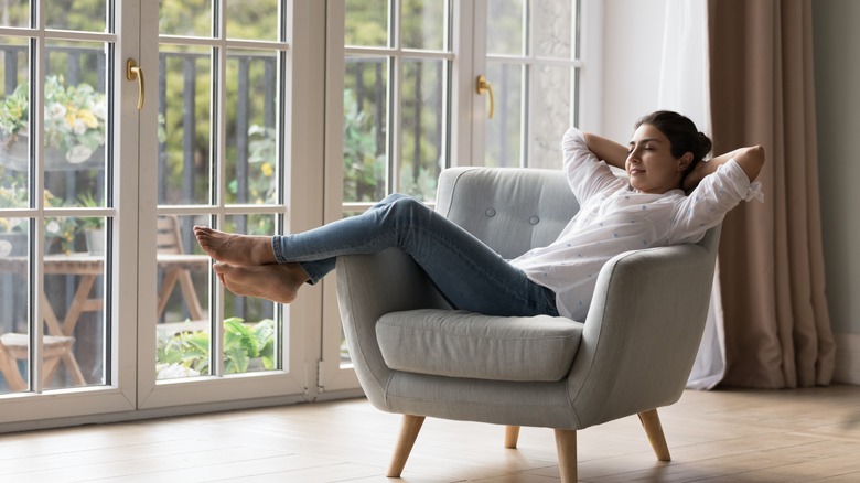 woman relaxing by closed windows