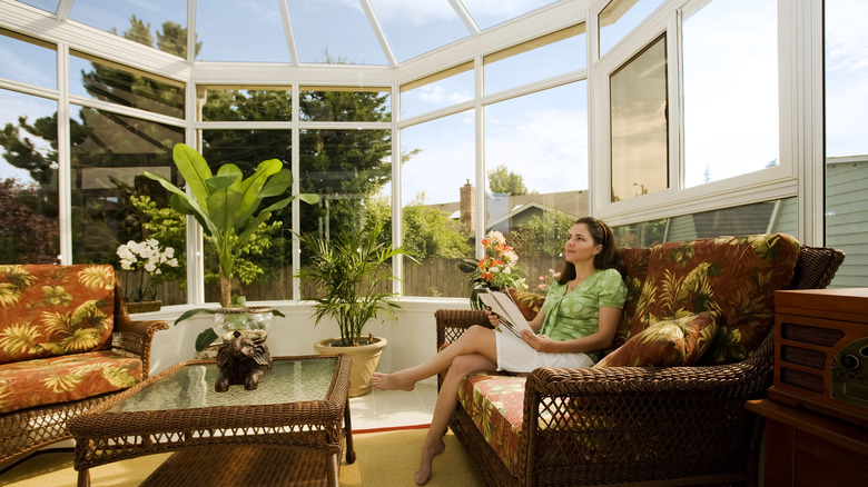 Woman relaxing in a sunroom