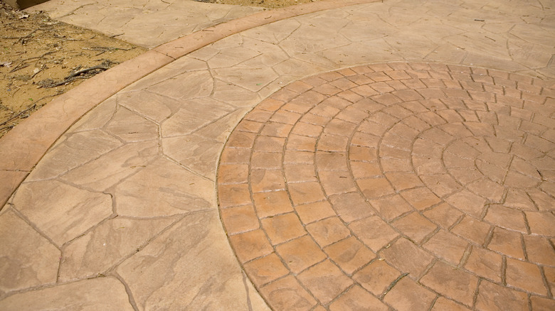 pressed concrete patio with European fan and natural random stone patterns together