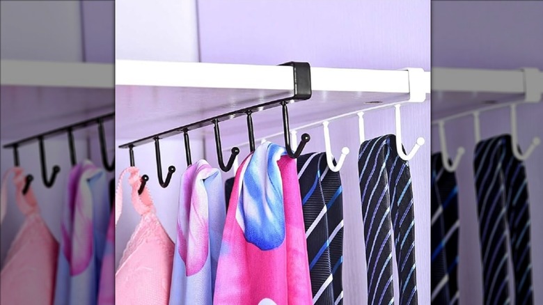 Under-shelf hooks holding clothing accessories from closet shelf