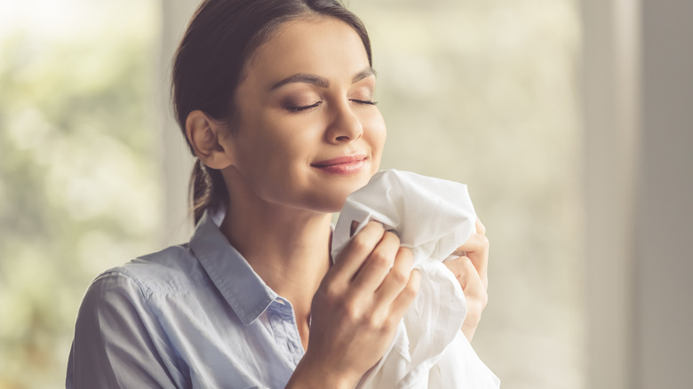 Woman smelling fresh laundry