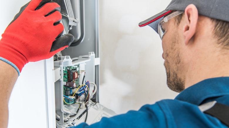 A technician looking in a furnace