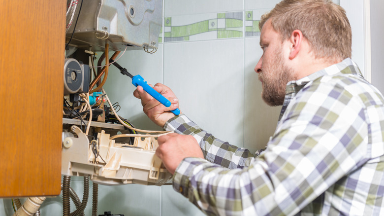 A technician working on a furnace