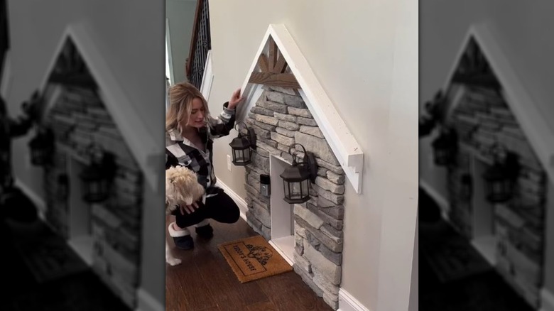 Doggy door framed with stone and lanterns