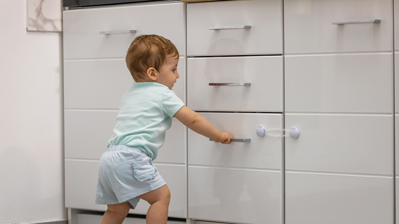 Baby trying to open drawer