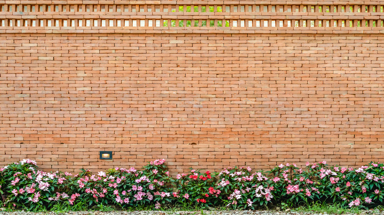 Neat, tall brick wall on the edge of a garden