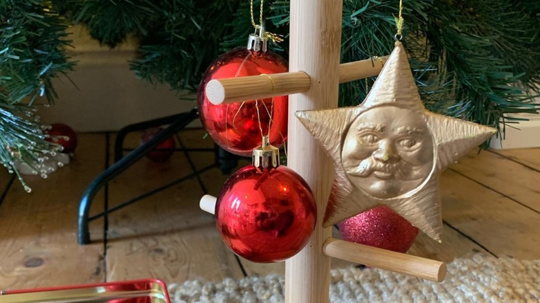 Ornaments hanging on wooden mug tree