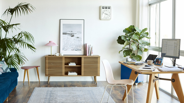 An office desk set in front of window in a home