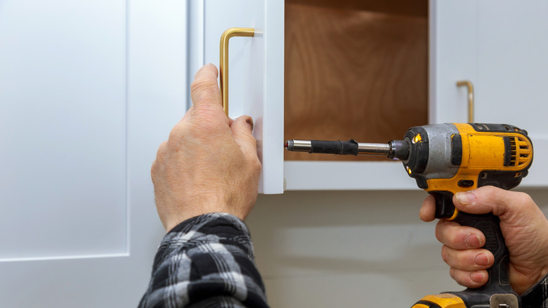 person upgrading cabinet hardware