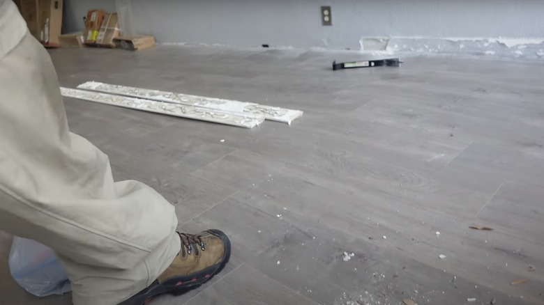 foot pressing down on flooring 