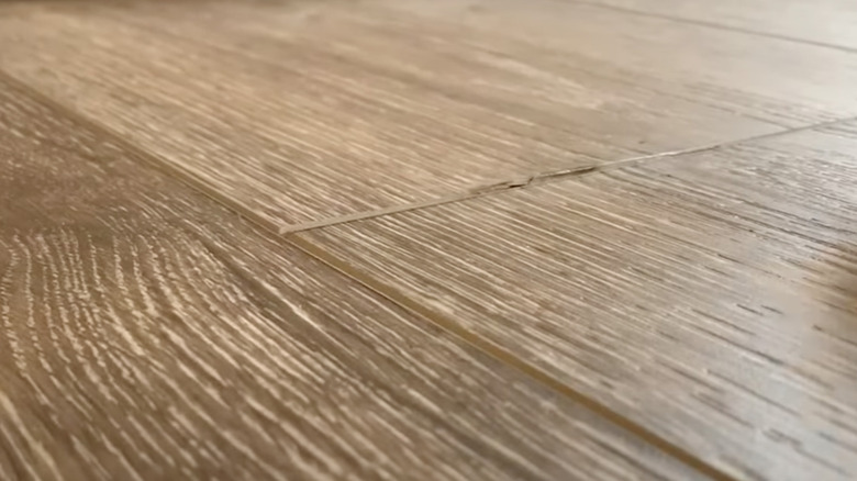 raised edges of laminate plank