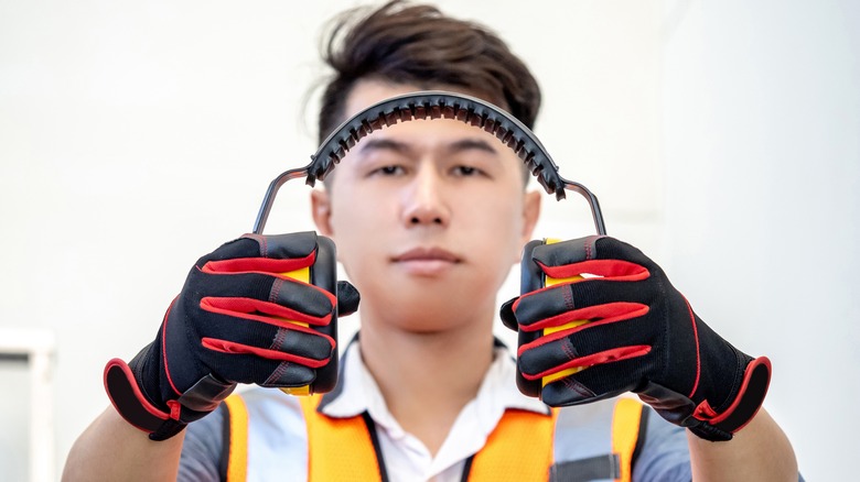 man wearing gloves and ear protectors