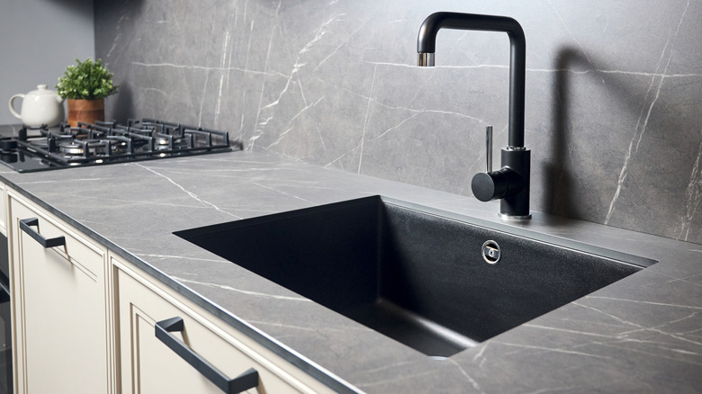 Matte black kitchen sink, faucet, and cabinet hardware