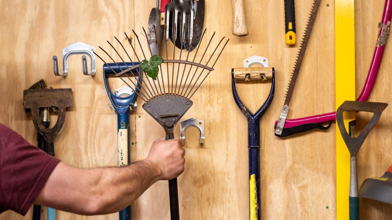 Hand reaching for garden tool