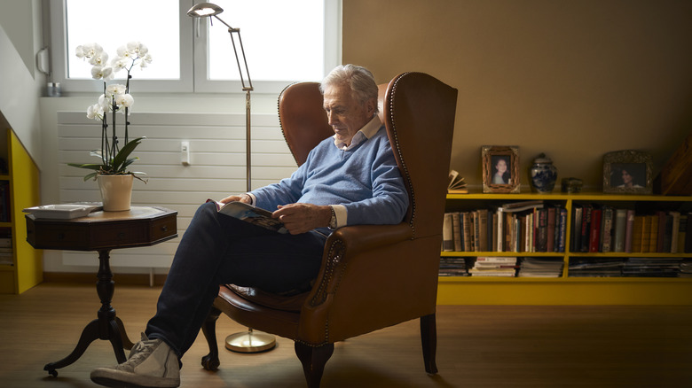 Man reading in armchair