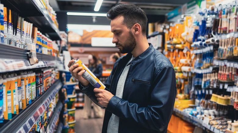 Person shopping for construction adhesives