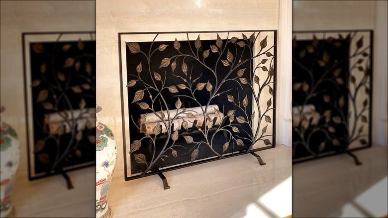 wrought iron fireplace screen with vine and leaf designs