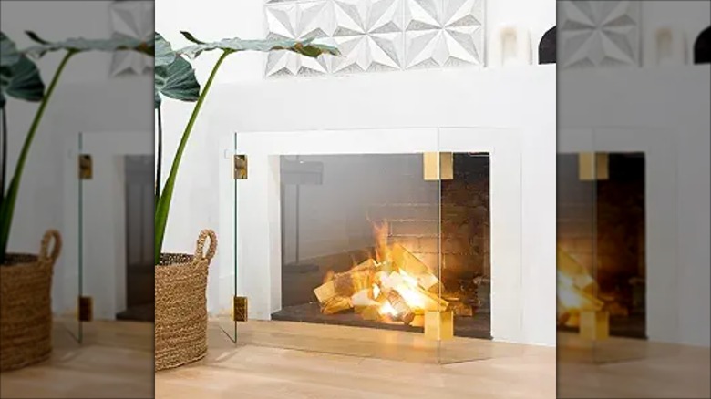 Three-panel tempered glass guard fence in front of a fireplace