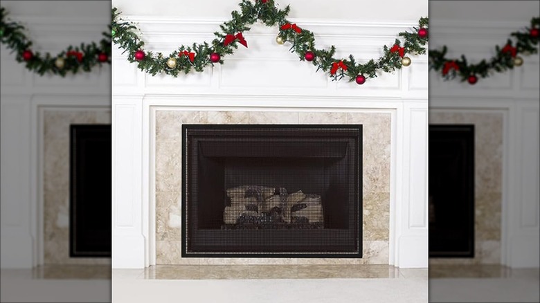 Simple black mesh screen barrier over a decorative fireplace