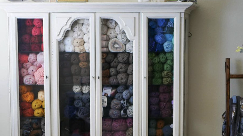 Craft supplies stored in china cabinet