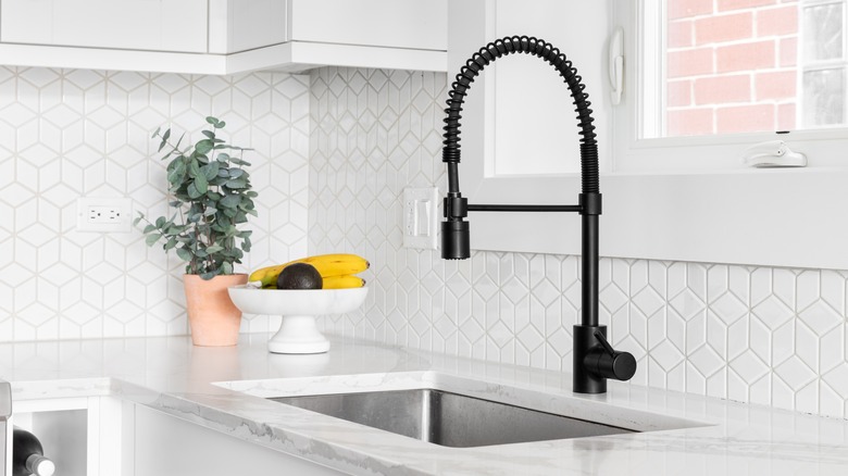 Kitchen counter with faucet and a 3-D tile backsplash