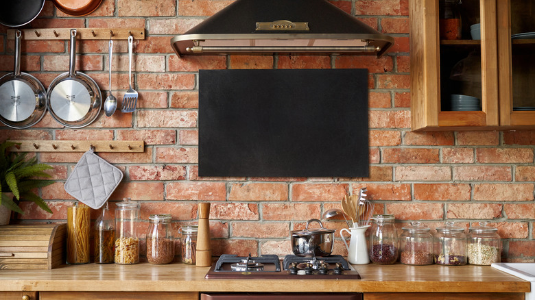 Rustic kitchen with masonry backsplash and wood cabinets