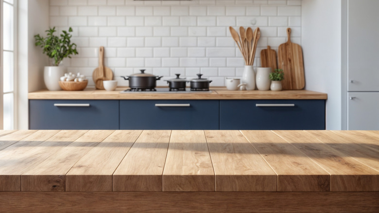 rustic butcher block countertop in navy blue and white kitchen