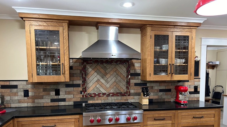 traditional kitchen with wooden cabinets and etched glass inserts