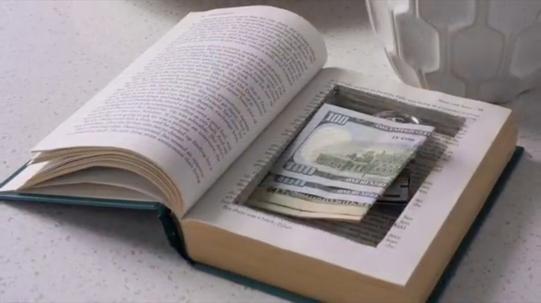 watch and money inside book