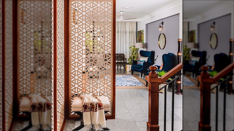 A geometric metal trellis screen in entryway