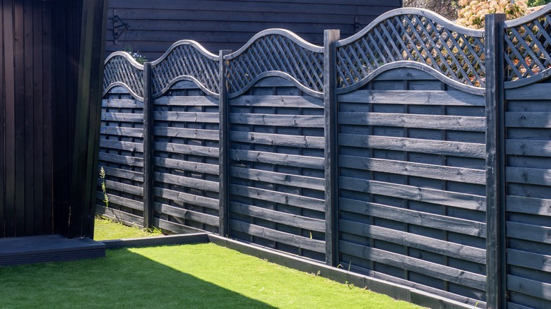 Trellis top dark wood fence