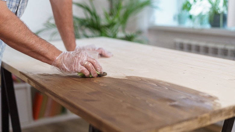 Person applying stain with rag