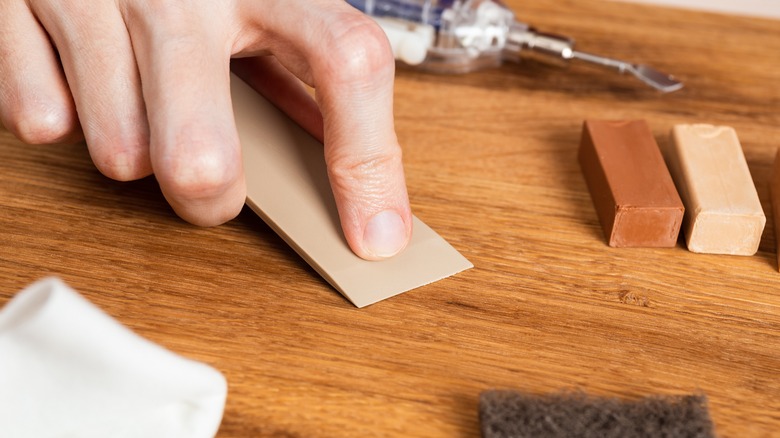 Person using wax on countertop