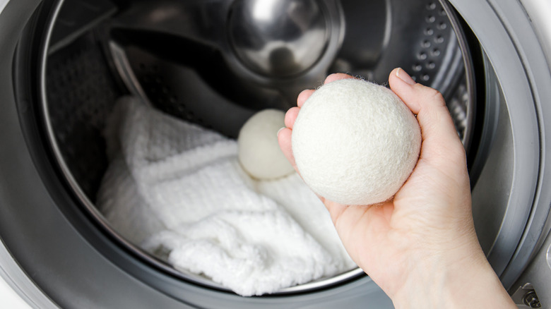 Woman holding wool dryer ball