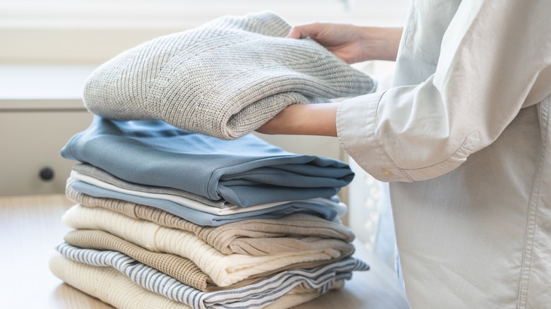 A woman folding clothes