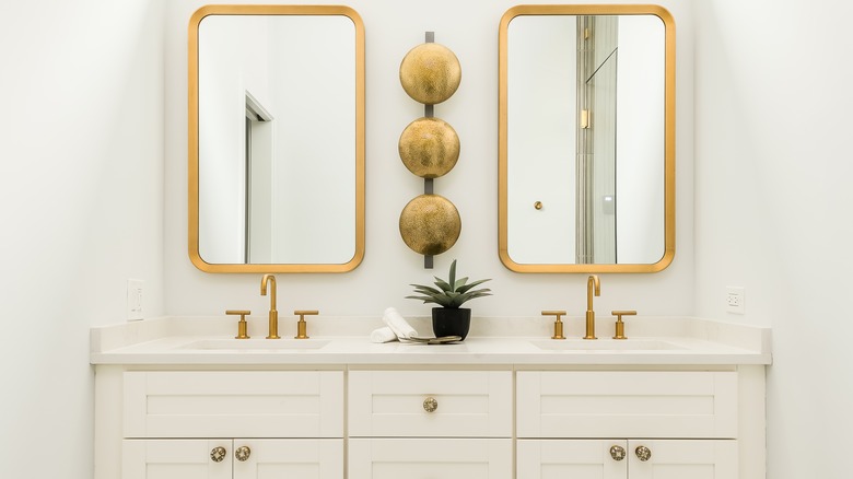 white bathroom with gold fixtures