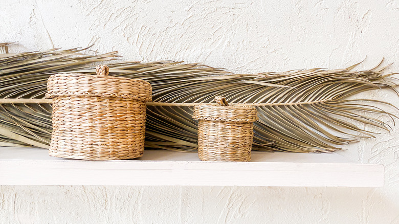 Feather and baskets on shelf