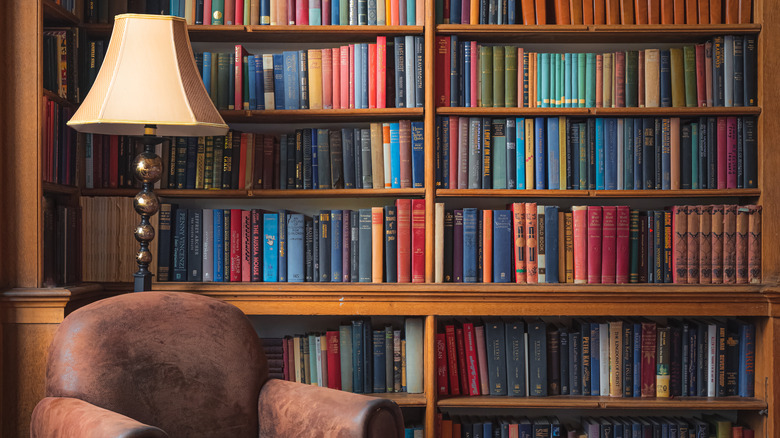 a lamp next to bookshelf